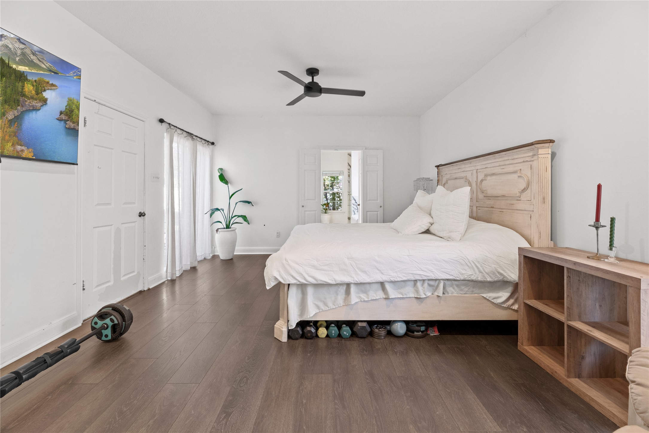14926 Camino Rancho Drive Houston, TX 77083 - Photo 11 of 22 The spacious primary bedroom showcases high ceilings and convenient direct access to its private en-suite bath and walk-in closet.