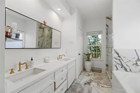 a bathroom with a sink mirror and toilet
