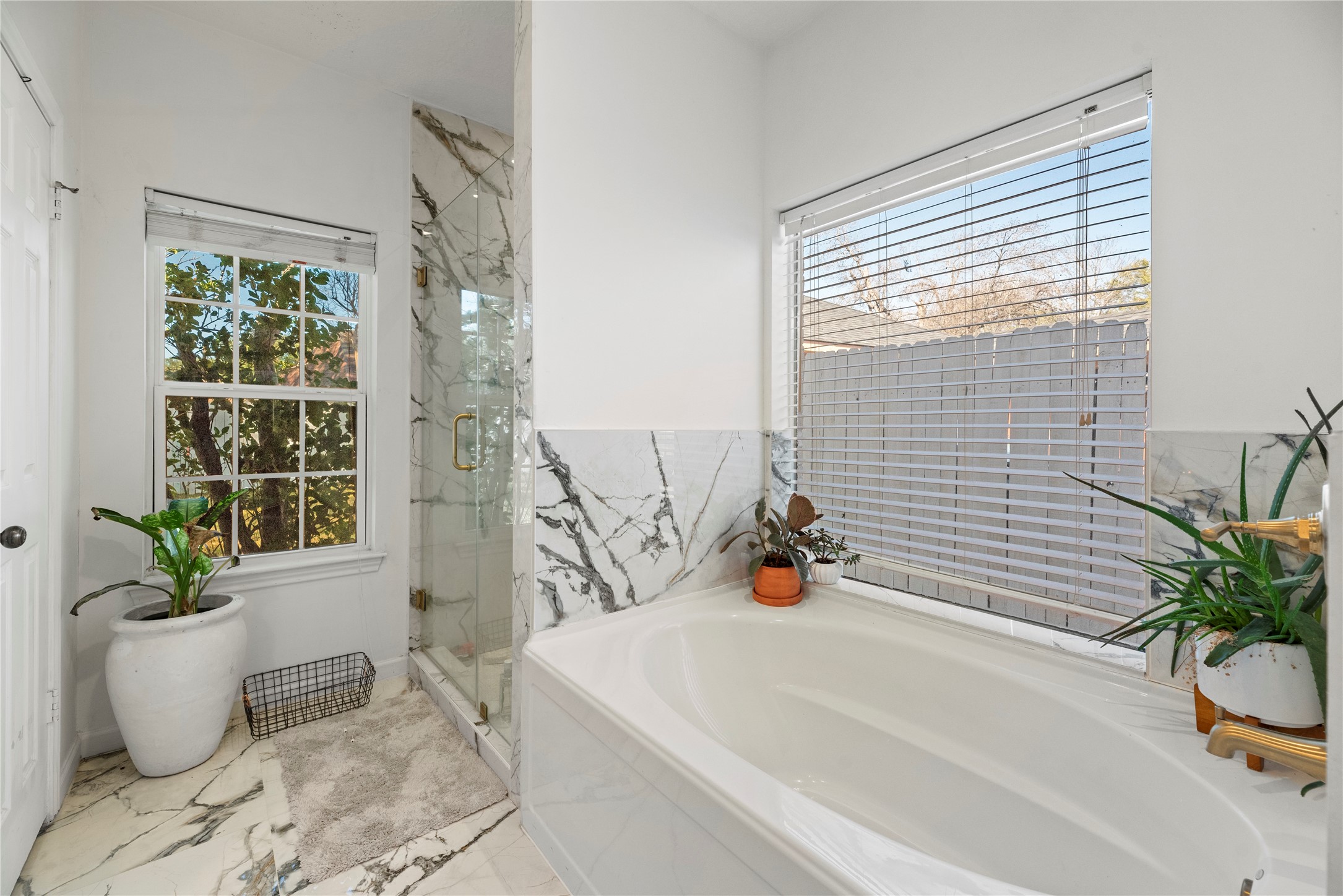 14926 Camino Rancho Drive Houston, TX 77083 - Photo 13 of 22 The modern glass-enclosed shower paired with the soaking tub creates a perfect blend of modern style and relaxation.