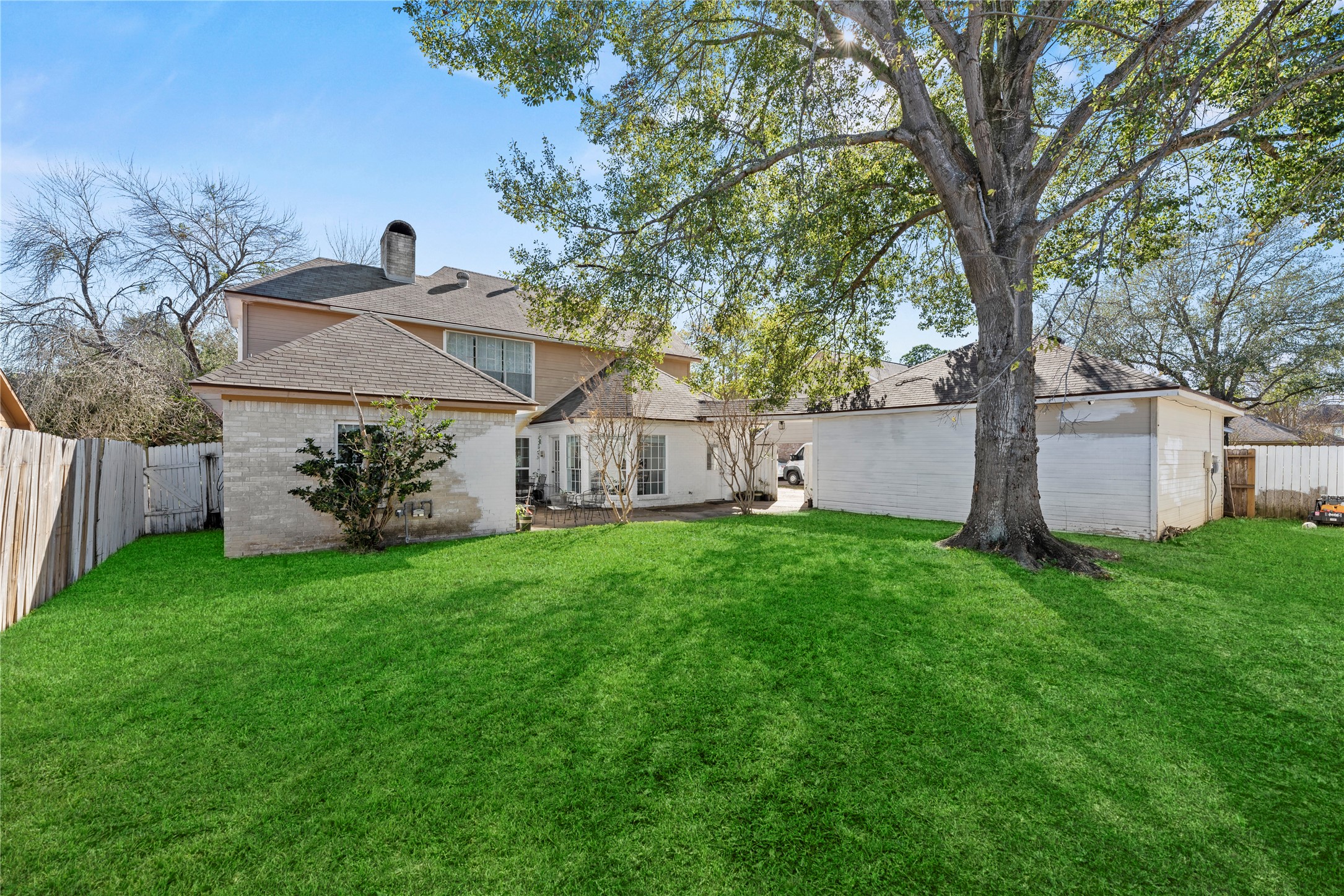 14926 Camino Rancho Drive Houston, TX 77083 - Photo 19 of 22 Step out and discover the inviting backyard, offering a wonderful green space for outdoor activities and relaxation.