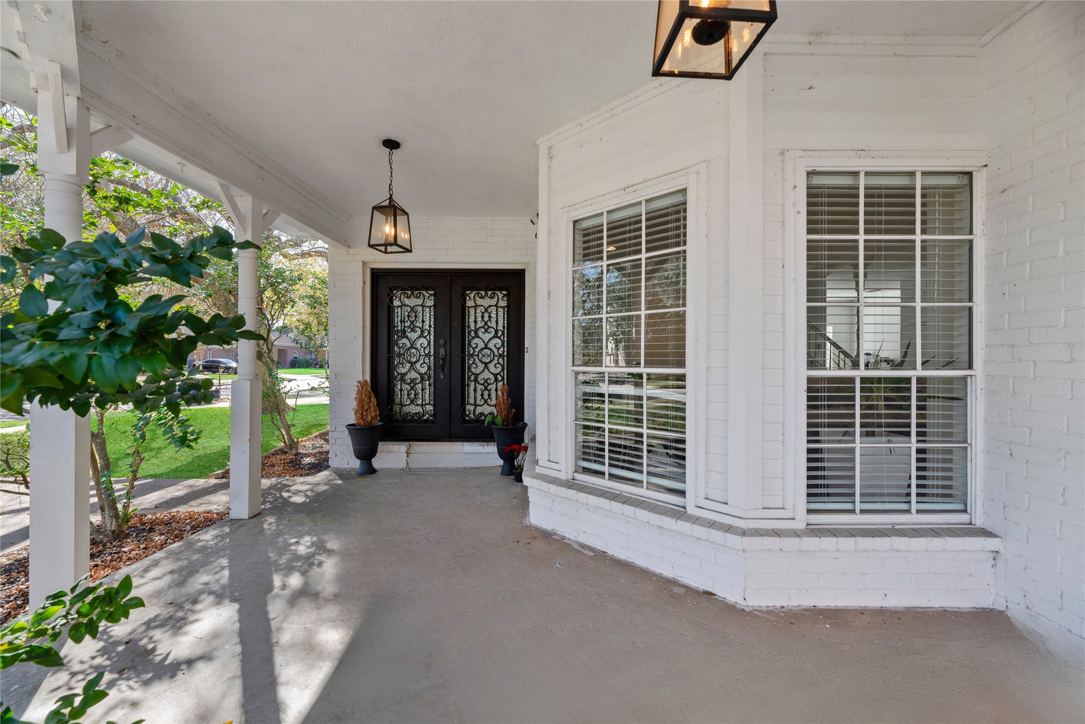 14926 Camino Rancho Drive Houston, TX 77083 - Photo 2 of 22 The covered front porch at 14926 Camino Rancho showcases classic brick charm, stately double doors, and a graceful bay window—setting the stage for the quality and character found throughout the home.