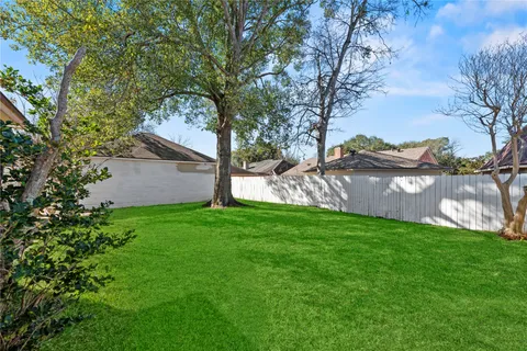 a view of a backyard with large trees