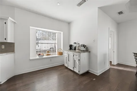 a room with window dryer and chandelier