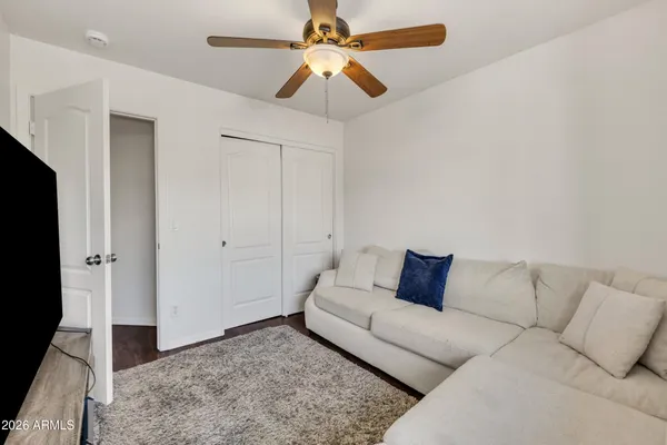a bedroom with a bed and a ceiling fan