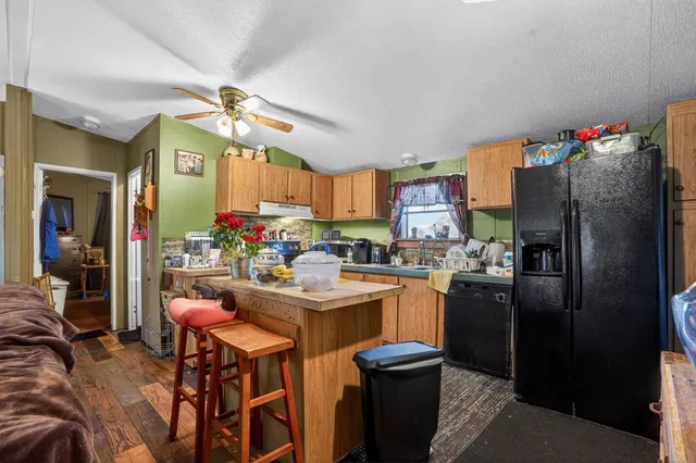 a view of a dining room kitchen with furniture and a chandelier
