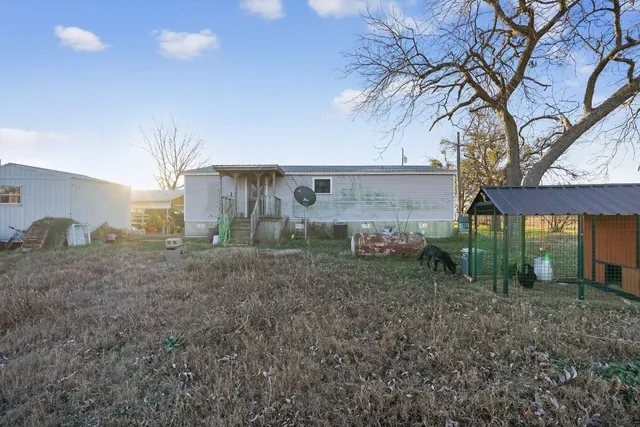 a view of a house with a backyard
