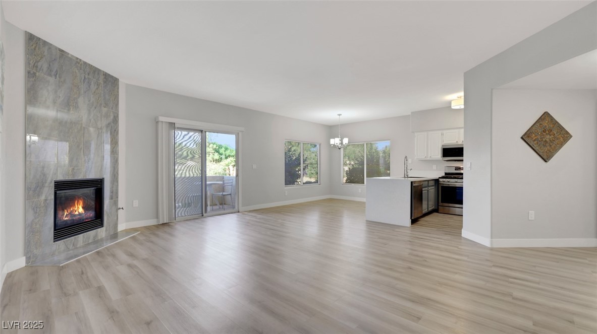 4921 Black Bear Road, Unit 104 Las Vegas, NV 89149 - Photo 2 of 35 Great room looking to kitchen and dining room space with Gas Fireplace