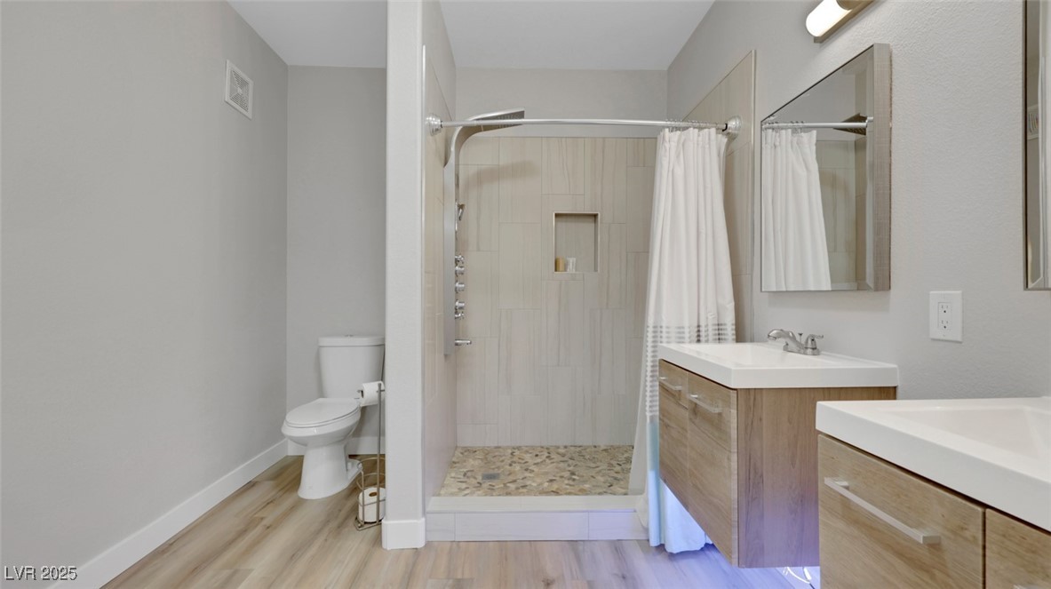 4921 Black Bear Road, Unit 104 Las Vegas, NV 89149 - Photo 22 of 35 Primary Bath with Dual Floating Vanities with LED lighting and Upgraded Shower Head