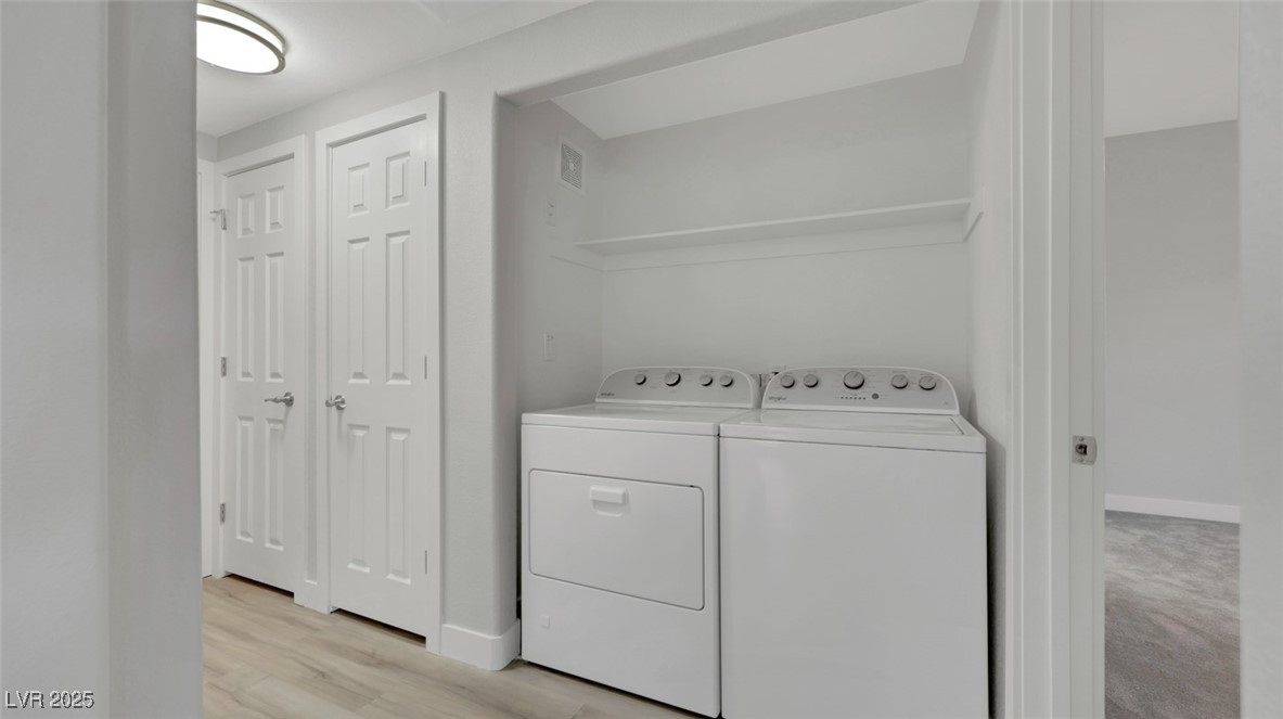 4921 Black Bear Road, Unit 104 Las Vegas, NV 89149 - Photo 24 of 35 Laundry room off great room situated between primary suite and second bedroom