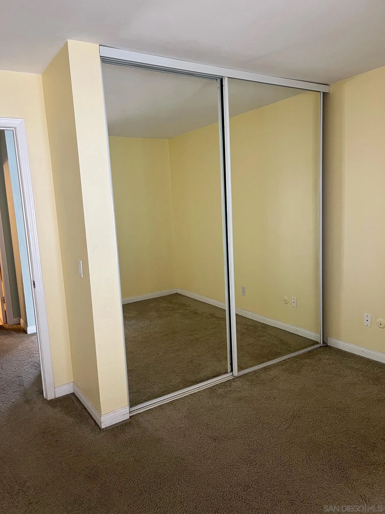 8332 Regents Road, Unit 1M San Diego, CA 92122 - Photo 12 of 18 an empty room with sliding door