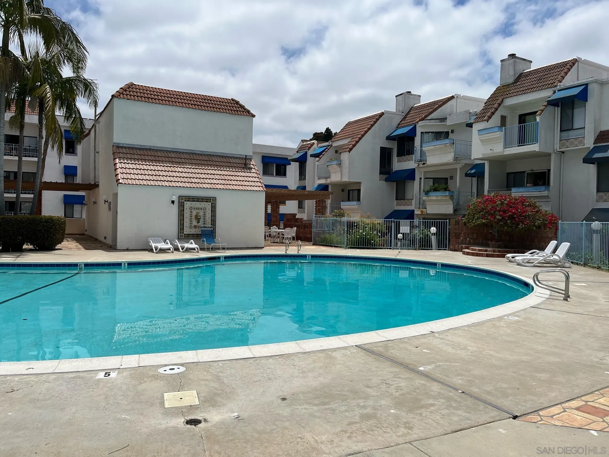 8332 Regents Road, Unit 1M San Diego, CA 92122 - Photo 17 of 18 a front view of a house with a garden and a yard