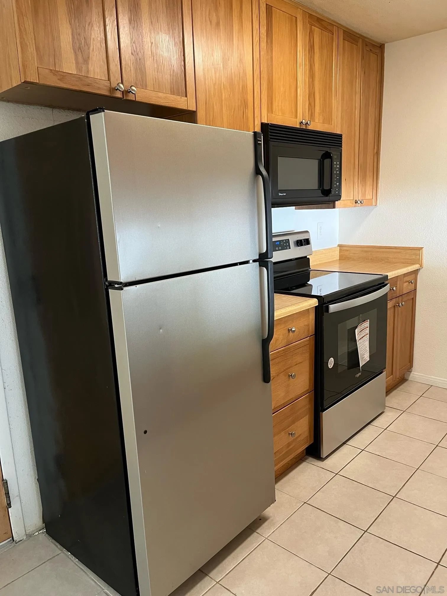 8332 Regents Road, Unit 1M San Diego, CA 92122 - Photo 6 of 18 a white refrigerator freezer and a stove sitting inside of a kitchen