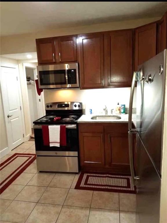 2807 Middle Road Glenshaw, PA 15116 - Photo 14 of 34 a kitchen with stainless steel appliances a stove a microwave and cabinets