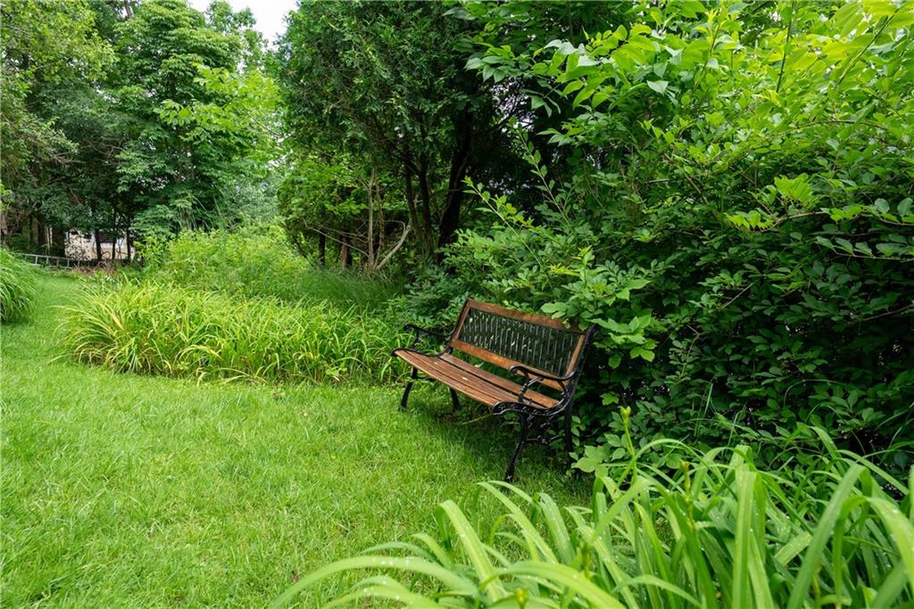 2807 Middle Road Glenshaw, PA 15116 - Photo 9 of 34 a wooden bench sitting in the middle of a forest