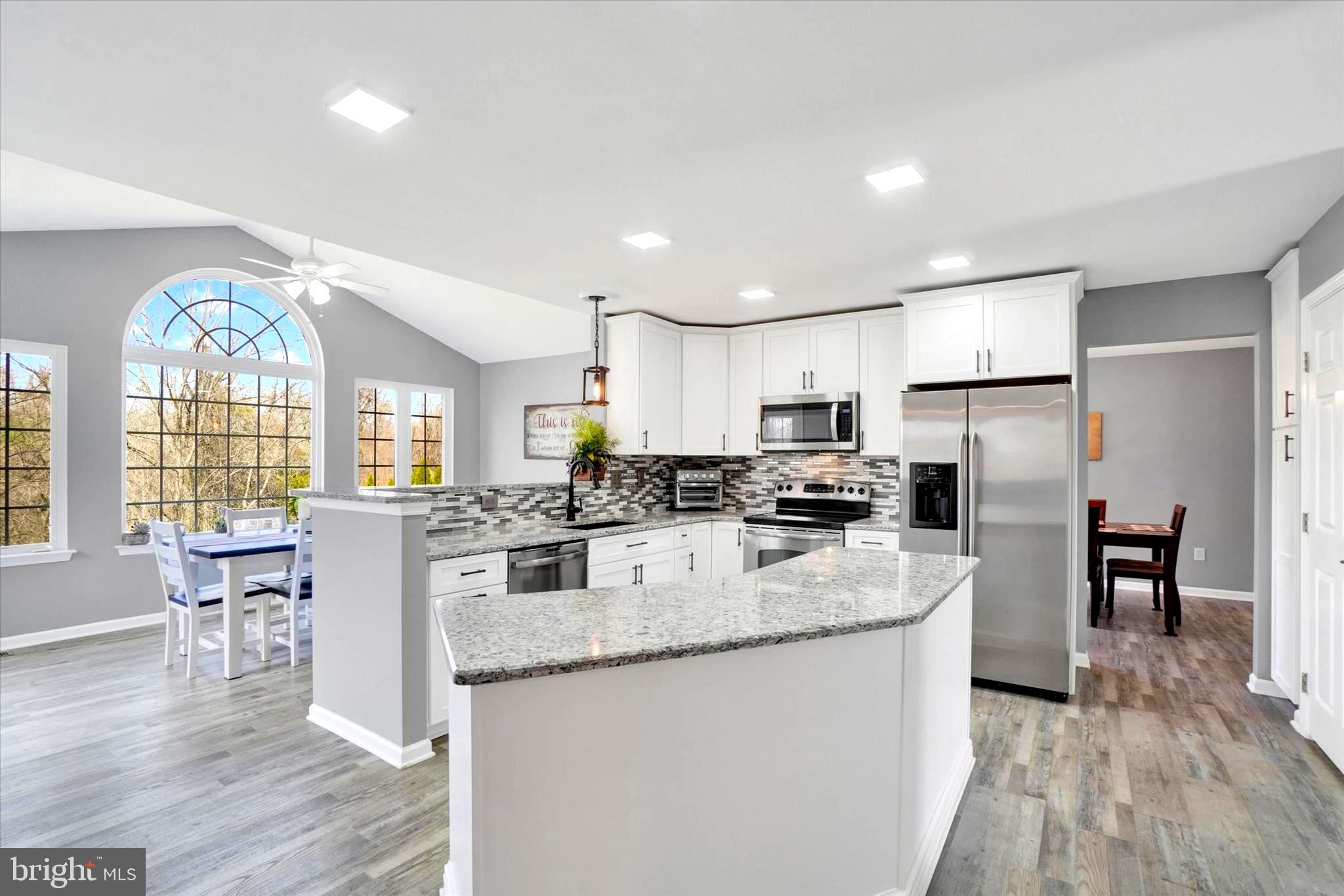 2512 Codorus Lane Spring Grove, PA 17362 - Photo 19 of 42 a large kitchen with kitchen island a large counter top space a sink appliances and cabinets