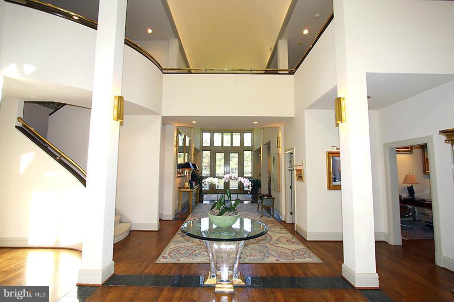 10831 Lockland Road Potomac, MD 20854 - Photo 2 of 16 a view of a dining room with furniture wooden floor and a chandelier