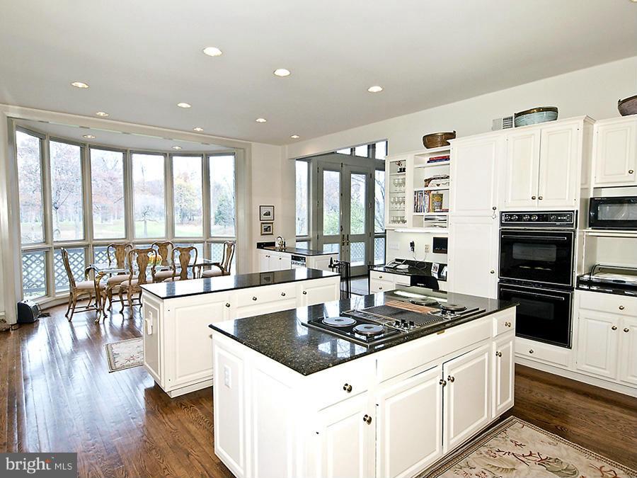 10831 Lockland Road Potomac, MD 20854 - Photo 6 of 16 a large kitchen with stainless steel appliances a large window and a stove