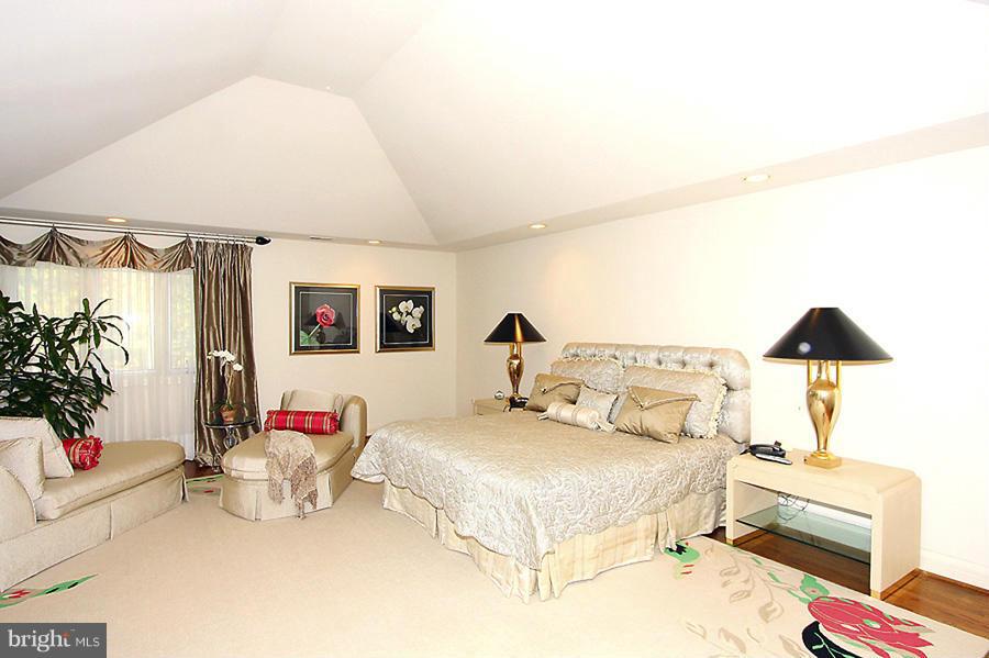 10831 Lockland Road Potomac, MD 20854 - Photo 9 of 16 a bed room with a bed and a lamp