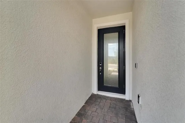 a kitchen with refrigerator and cabinets
