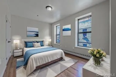 a bedroom with a bed potted plant and a window