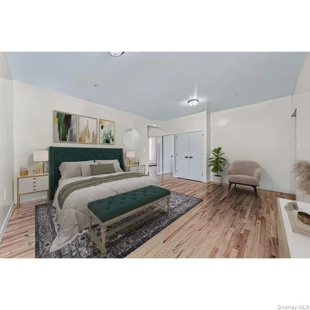 a bedroom with a bed and a painting on the wall