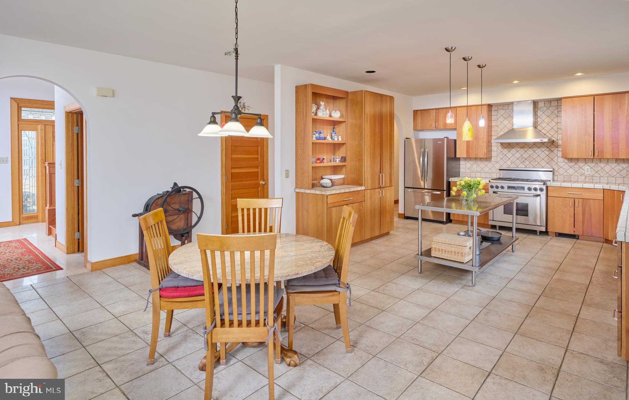 810 Callowhill Road Perkasie, PA 18944 - Photo 13 of 36 a living room with furniture a dining table and a chandelier