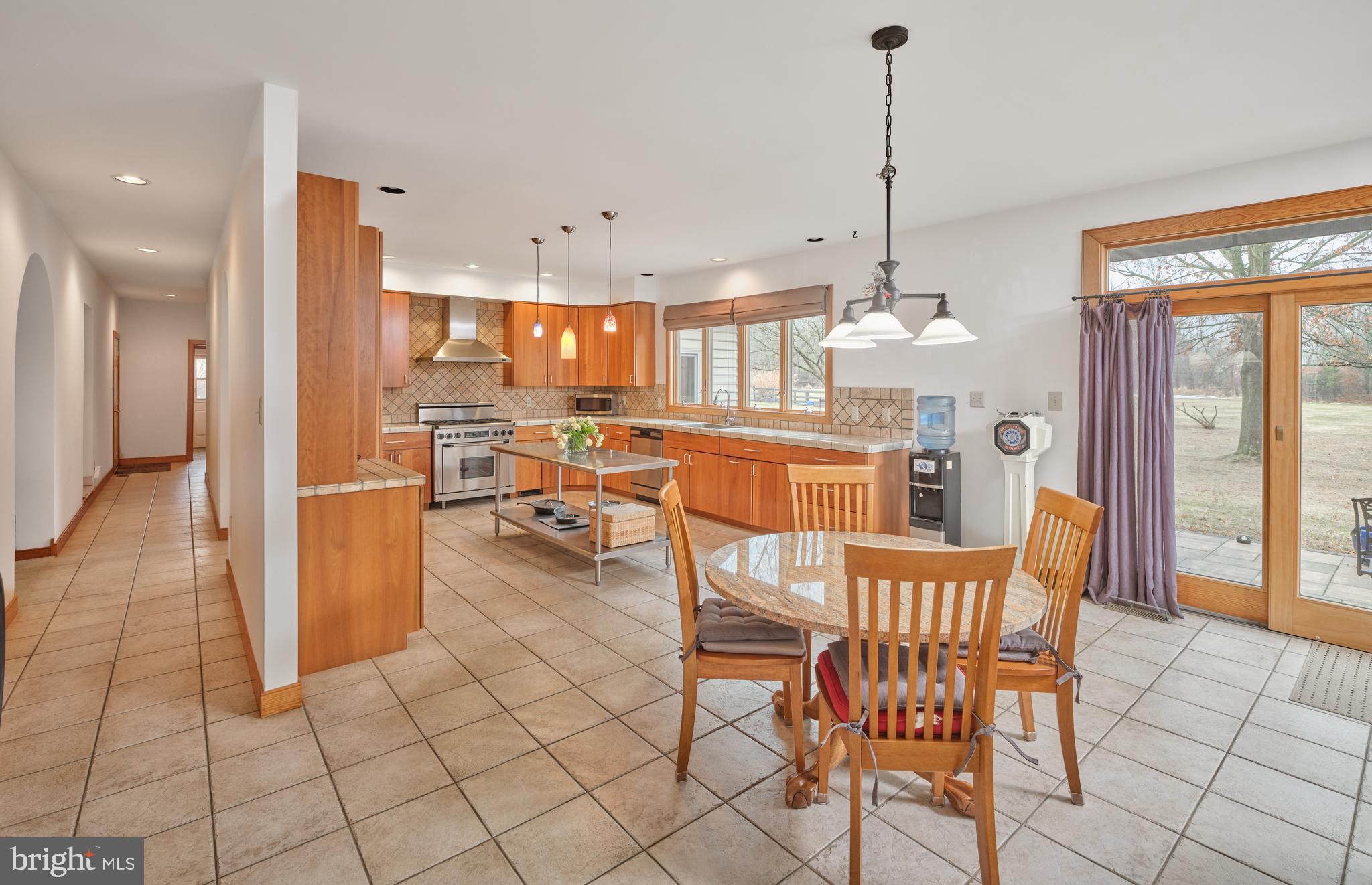 810 Callowhill Road Perkasie, PA 18944 - Photo 10 of 36 a view of a dining room and livingroom with furniture wooden floor a chandelier