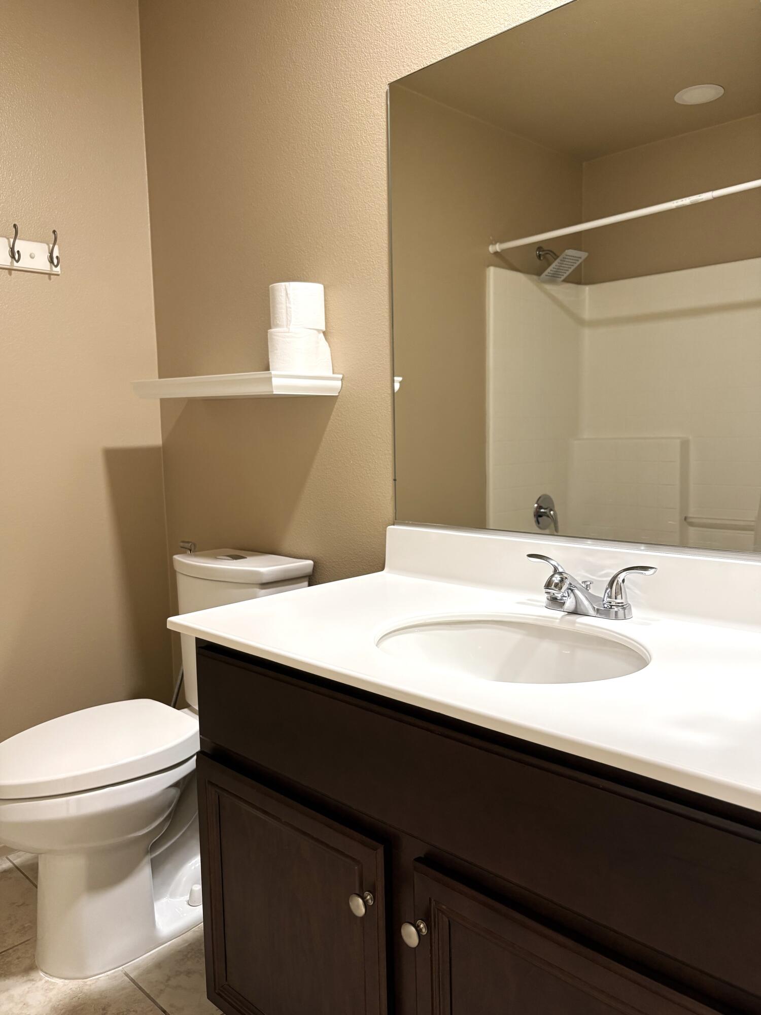 84175 Tramonto Way Indio, CA 92203 - Photo 15 of 22 a bathroom with a sink a toilet and mirror