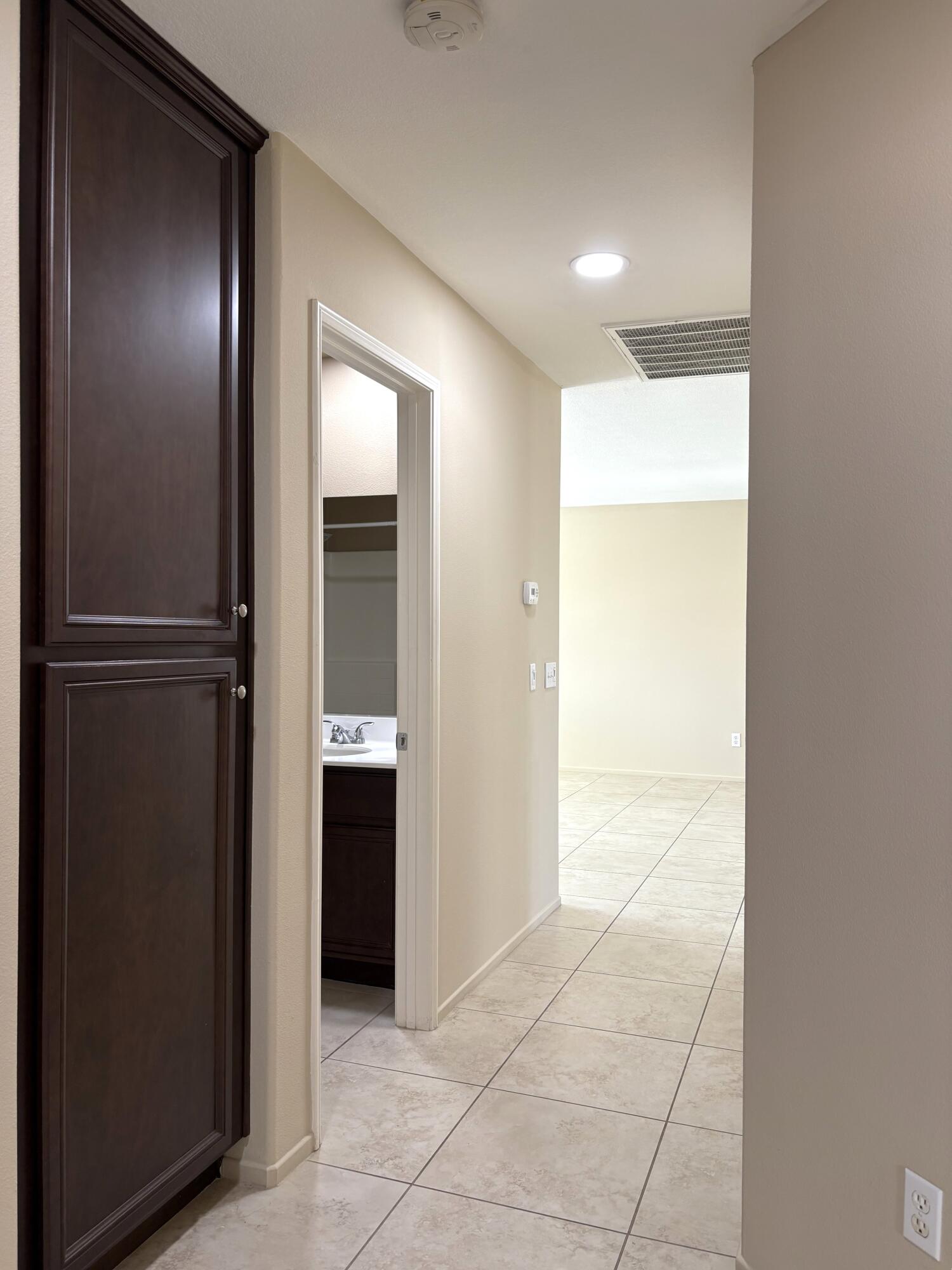 84175 Tramonto Way Indio, CA 92203 - Photo 17 of 22 a view of a hallway with wooden shelves