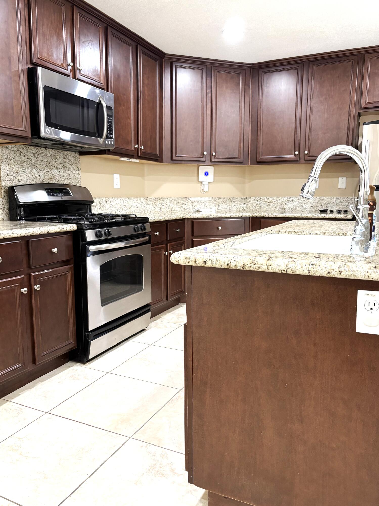 84175 Tramonto Way Indio, CA 92203 - Photo 5 of 22 a kitchen with granite countertop a sink stainless steel appliances and cabinets