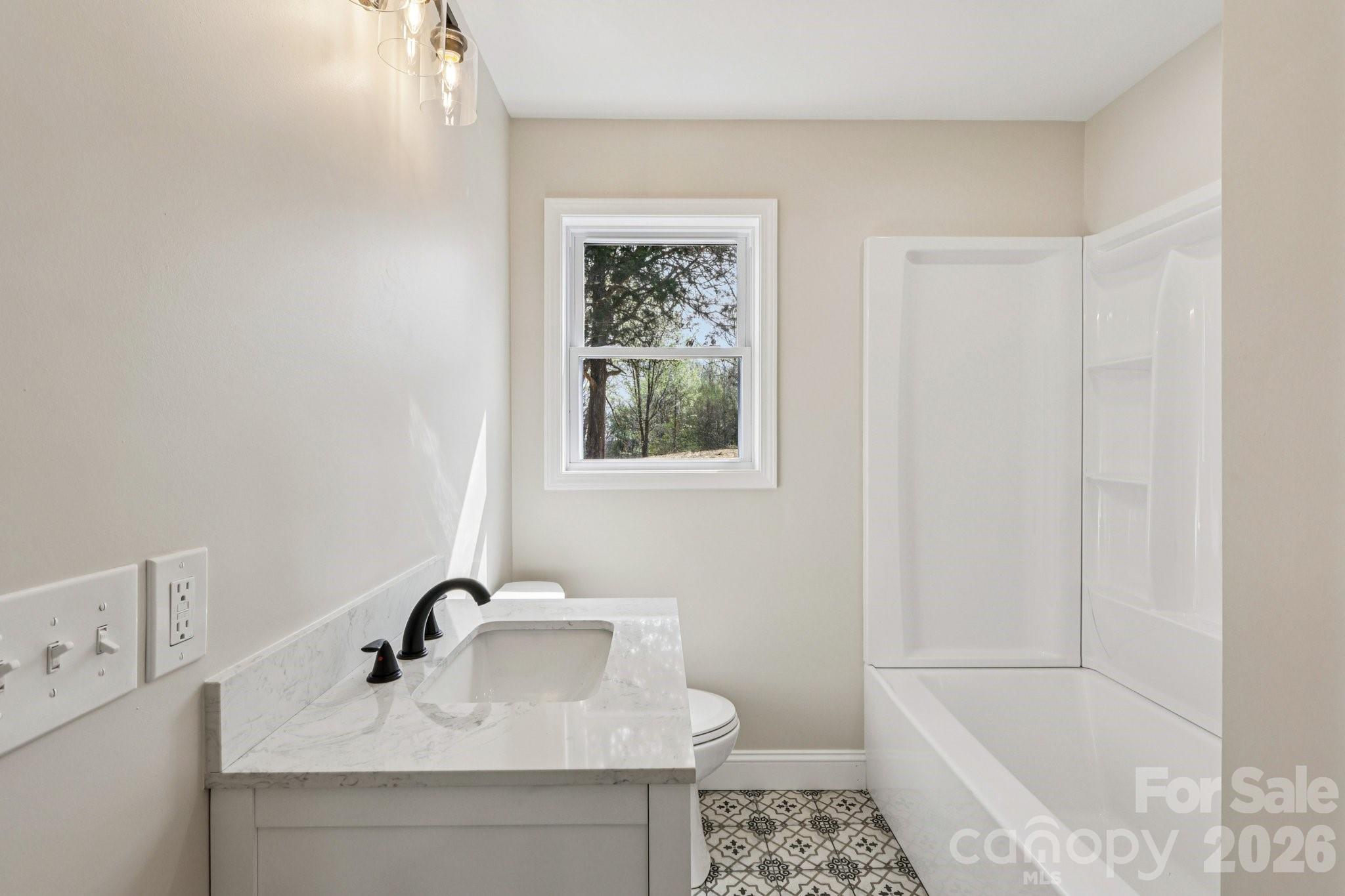 1403 Dudley Shoals Road Granite Falls, NC 28630 - Photo 19 of 20 a bathroom with a sink and a bathtub