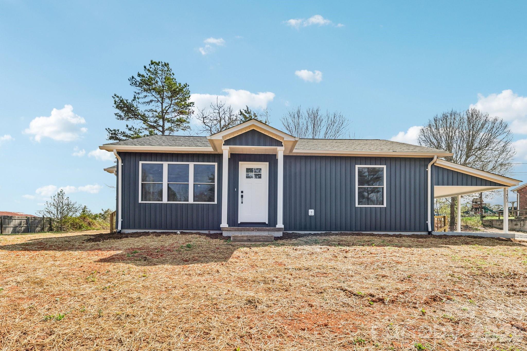 1403 Dudley Shoals Road Granite Falls, NC 28630 - Photo 3 of 20 a front view of a house with a yard