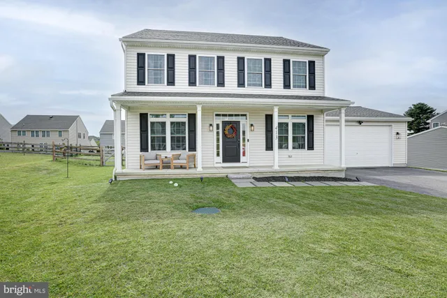 an aerial view of a house a yard basket ball court and outdoor seating