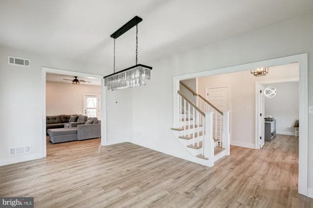 a living room with furniture and a view of kitchen