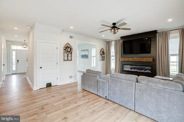 a kitchen with stainless steel appliances a table chairs sink and cabinets