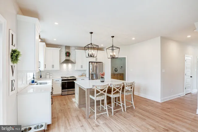 a kitchen with stainless steel appliances granite countertop a sink and cabinets