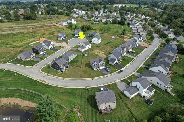 an aerial view of a house with swimming pool and outdoor space