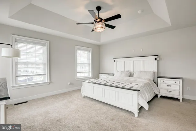 a white bath tub sitting in a bathroom next to a window