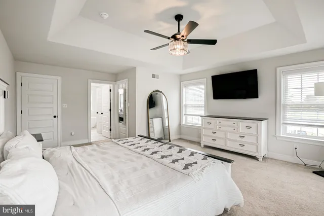 a white bath tub sitting in a bathroom next to a window