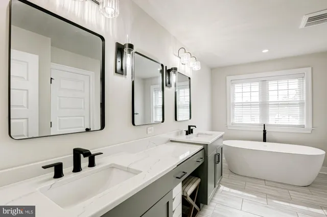 a bedroom with a bed a window and a flat screen tv