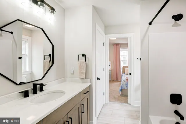 a view of a livingroom with wooden floor and a flat screen tv