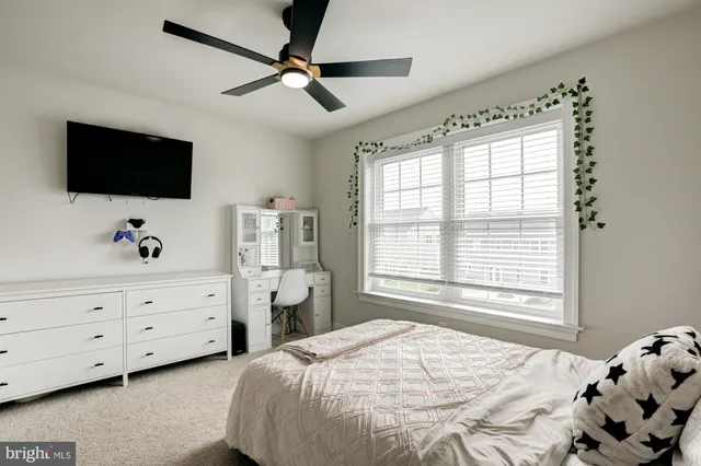 a spacious bedroom with a bed and a chandelier
