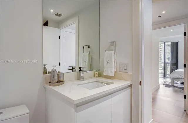 a utility room with dryer washer and empty racks