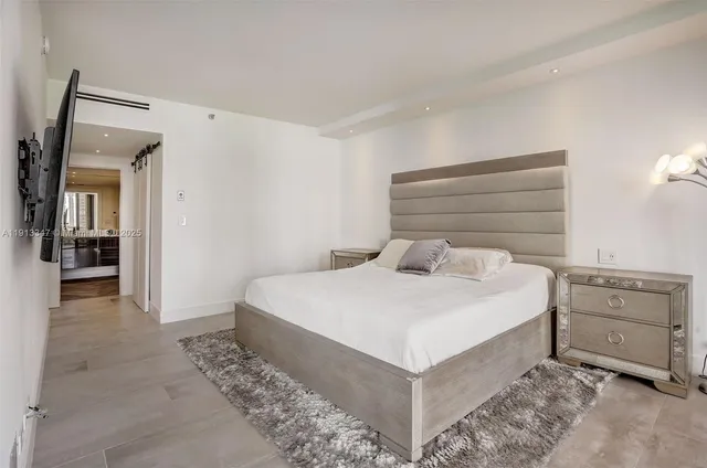 a bedroom with a bed and cabinet