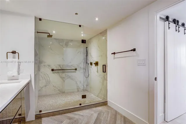 a bathroom with a shower and a sink