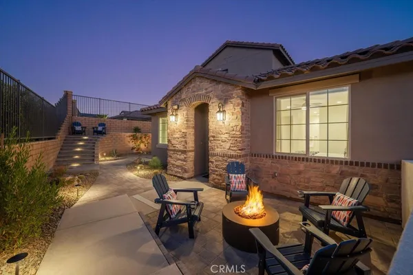 a view of a house with backyard and sitting area