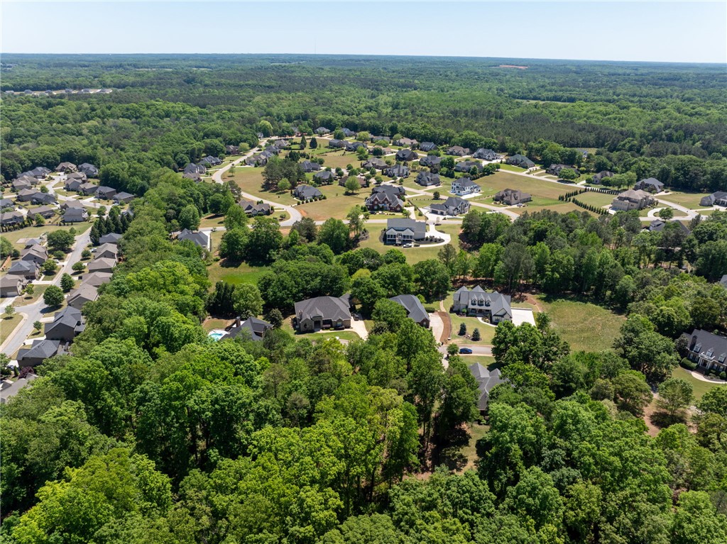 131 Loudwater Drive Anderson, SC 29621 - Photo 13 of 20 An aerial view captures a vibrant neighborhood surrounded by expansive woodlands and residential streets.