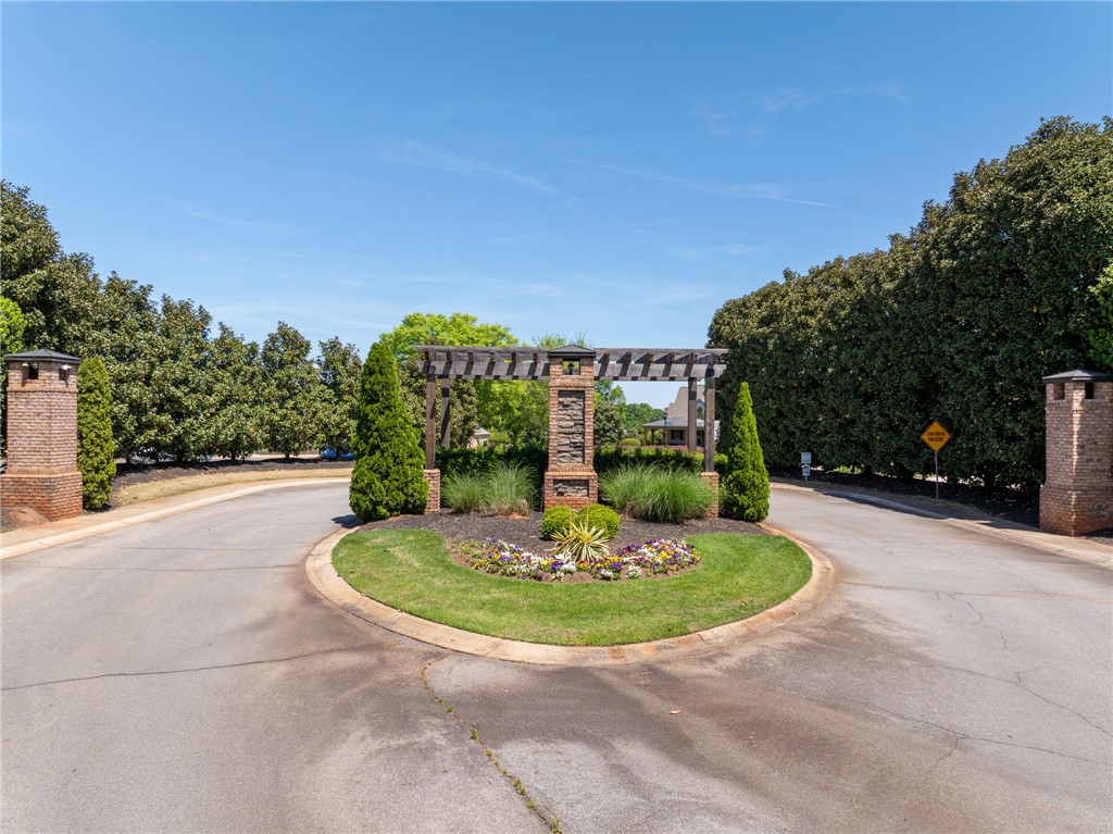 131 Loudwater Drive Anderson, SC 29621 - Photo 19 of 20 This grand community entrance features a circular drive and lush landscaping.
