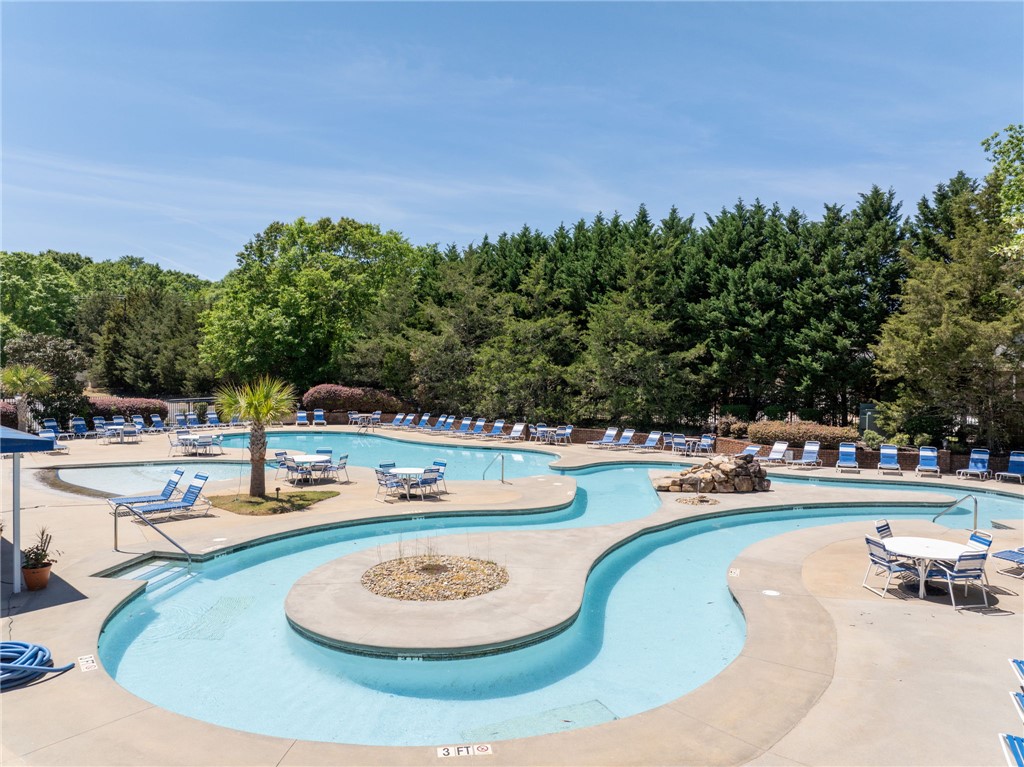 131 Loudwater Drive Anderson, SC 29621 - Photo 10 of 20 This outdoor pool area offers relaxation and recreation with ample seating amidst lush greenery.