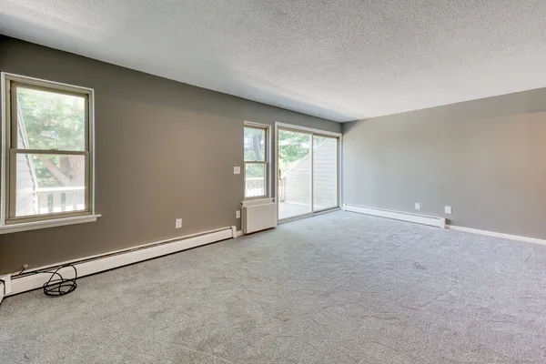 a kitchen with cabinets stainless steel appliances and wooden floor